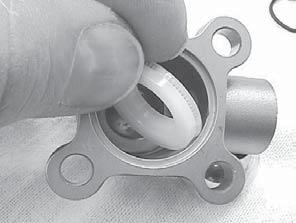 Install the flat washer over the seal, and apply silicone lube to hold it in place.