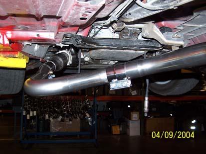 Raise the passenger side exhaust tube assembly and connect it to the passenger side collector.