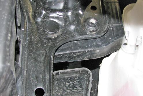 13. Using a 16MM socket, remove the bolt from the backside of the middle bumper bracket.
