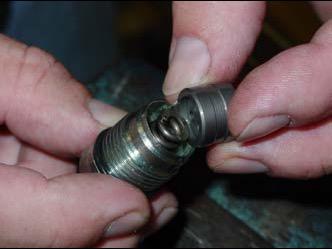 Use a wrench to unscrew supplied nut in order to remove valve cap. Be careful to hold end of valve while doing this!