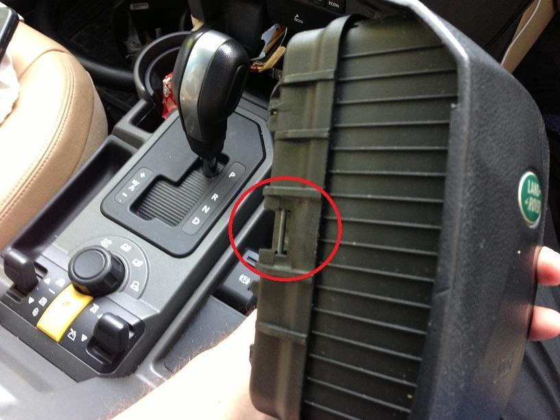 Once you have your tool, slide it into the small hole in the steering column to release the one side.