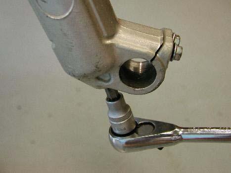 Use an 8mm Allen wrench and remove the RH and LH fork drain bolts, these bolts also retain the internal damping