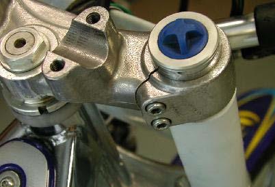 Use a 5mm Allen wrench and remove the 2 RH and 2 LH triple clamp pinch bolts.