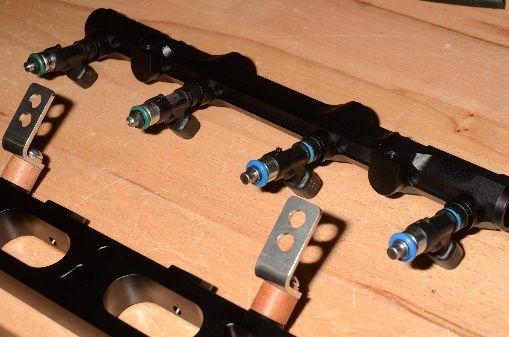 NOTE: these mounting brackets can be installed backwards, by mistake. Push the injectors into the fuel rail ports.