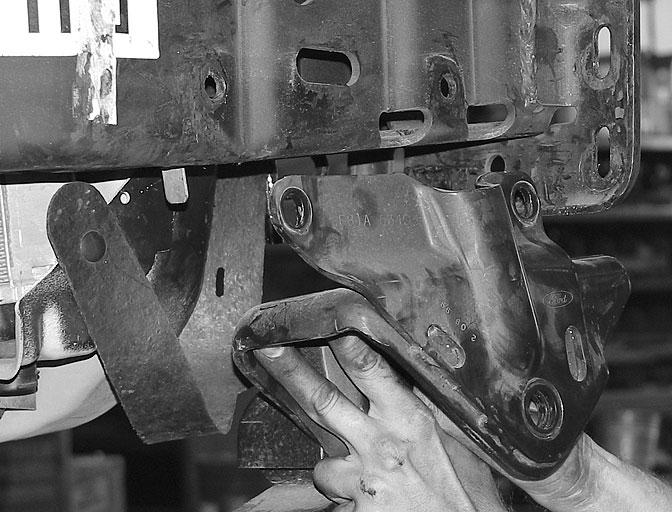 SEE PHOTOS BELOW. 5. Remove the seven bolts securing each front leaf spring bracket to the frame and slide the brackets off the frame. SEE PHOTOS BELOW. 6.