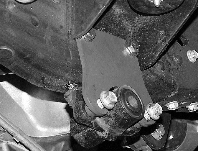 Remove the four bolts securing the rear shackle bracket to the frame.