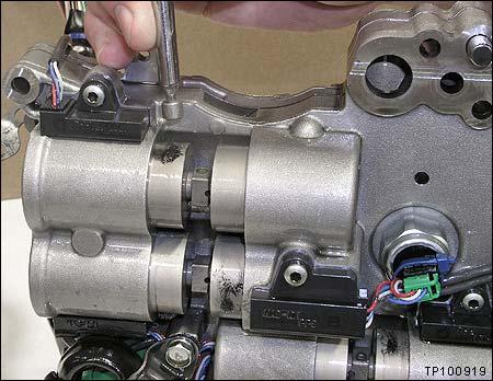 Installing Holding Pins (Special Tool J-50392) NOTE: This operation is required ONLY when the holding pins could not be completely installed before removal of the ACM from the transmission. 1.