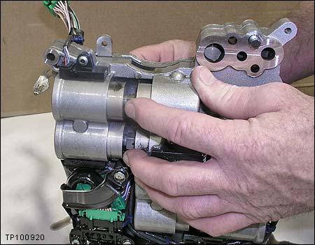 3. Hold the shift pistons in place while carefully inserting the holding pin into the valve body (see