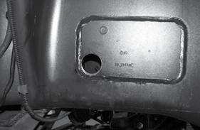 Locate the factory bump stop mounting hole.