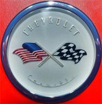 Original Chevrolet Logo with American Flag The original front emblem and horn button was designed to show a checkered flag crossed with an American flag.