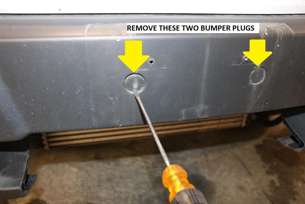 10) Remove the two bolts behind the bumper plugs. Use a 13mm socket / wrench for removal.