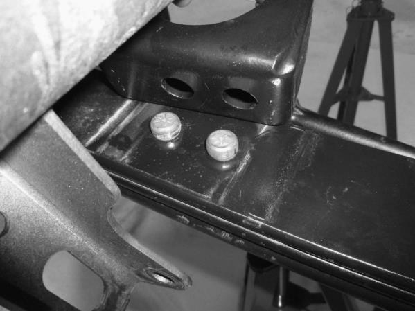 3b) Start from the passenger side. Place the leaf spring in the front spring hanger and insert the supplied18x2.