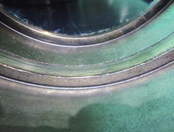 and housing Photo 3-1 Inner ring of a spherical roller bearing Scoring on large rib face of inner ring Roller slipping due to sudden acceleration and