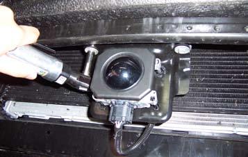 19. IF EQUIPPED WITH ADAPTIVE CRUISE CONTROL Remove two screws from adaptive cruise control sensor and let hang. 20.