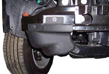 12. Remove three bolts and remove plastic bumper shield.