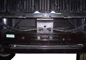 13. Remove two bolts from center grill support and remove support.