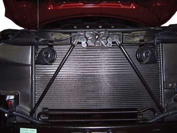 Remove two bolts from center grill support and remove support. 15.