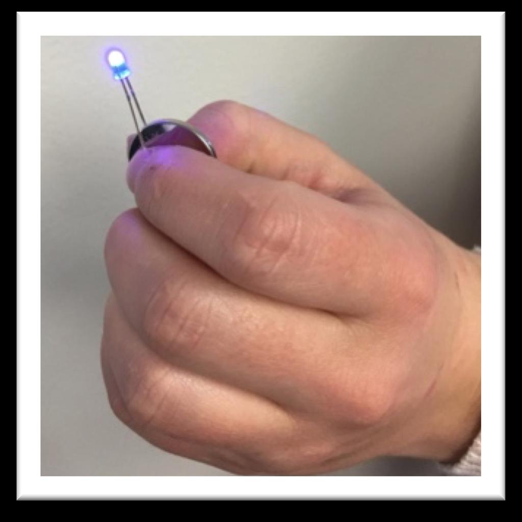 Using your thumb and forefinger, apply a small amount of pressure to the LED legs to ensure a good connection. The LED should light up. Connecting the LED to the battery created a circuit.