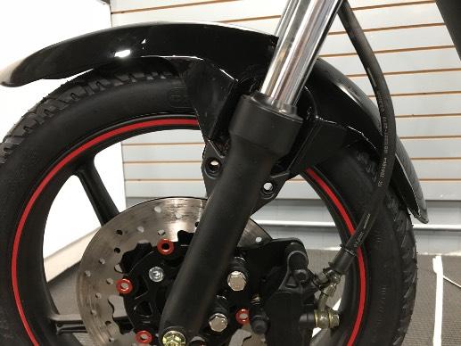It may be useful to turn the fork slightly to make room for the short spacer. Push the axel through the fork and place the washer before tightening the locking axel nut (16mm nut and 12mm bolt).