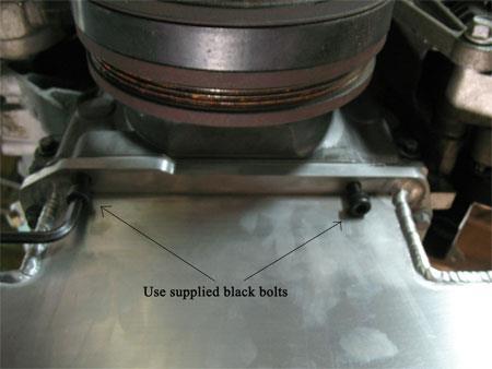 Install the two lower bell housing black bolts to position the oil pan correctly, Tighten until pan is flush with engine block.