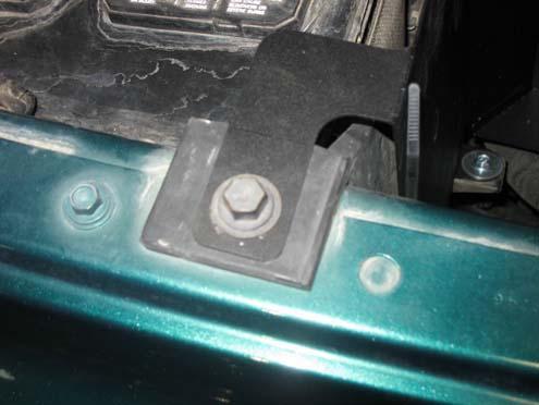 k) Align the small mounting tab with hole where the bolt was