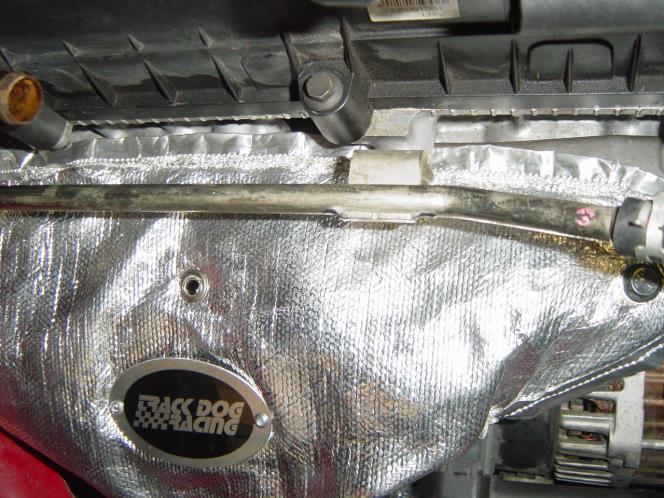 Make sure the heat shield is resting on top of the thin flange you bent down earlier as shown in Photo 1-9.