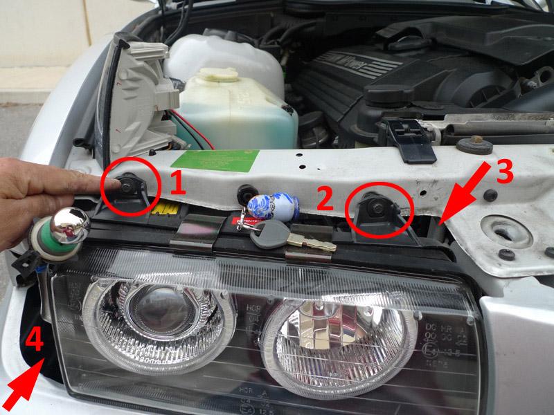 Once the plastic cover is removed, you will have to remove 4 nuts/screws from the headlight to get the headlight out of its housing.