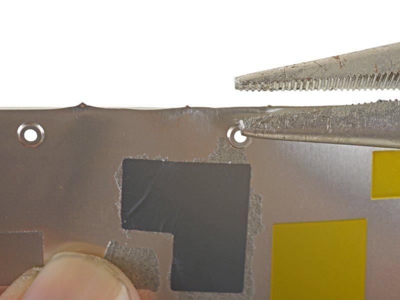Squeeze the sharp protrusion with a pair of pliers to flatten it.
