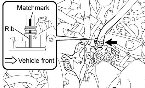 9. DISCONNECT THE BRAKE ACTUATOR HOSE a) Place a matchmark on the hose that aligns with the rib on the accumulator. This will be used during reassembly.