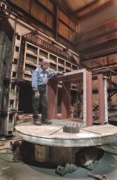 Journeyman millwrights shown above position a machined valve body for assembly with one of our many overhead cranes.