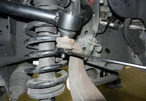(Fig 13) Install the completed strut assembly into the frame 180 degrees from the original orientation making sure that the offset of the top spacer is going in towards