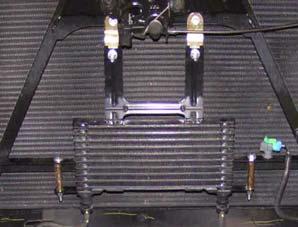c. Install transmission cooler on two kit brackets (2 S-shaped) with kit washer (1/4 SAE) and kit nut