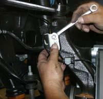 9. Disconnect the ABS line & brake line retaining bracket from the steering knuckle using a 10mm wrench.