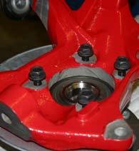 31. Attach the backing plate & hub bearing assembly to the new Skyjacker steering knuckle using the OEM hardware & 21mm socket. Note: Reinstall the O-Ring & use thread locking compound on the bolts.