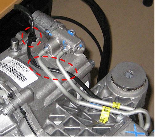 clutch. 21. Reinstall the electrical connector to the limited slip differential valve and harness to the clip. Route the electrical harness under the pressure lines as shown. 22.
