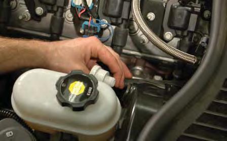 37. Remove the power brake check valve and hose from the brake booster grommet by pulling it