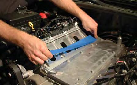 Cover the intake manifold ports with tape or clean rags to keep dirt and objects from