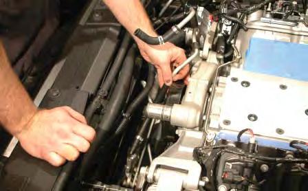 105. Cut or open the factory pinch clamp from the top barb on the power steering cooler.