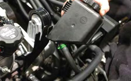 125. Connect the end of the 3/8 hose to the small barb on the power steering reservoir using the
