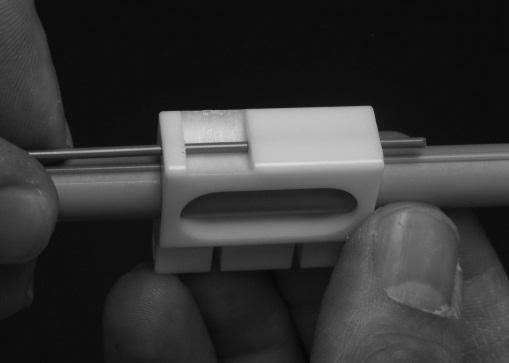 Push the cable into the slider, guiding it through the second hole