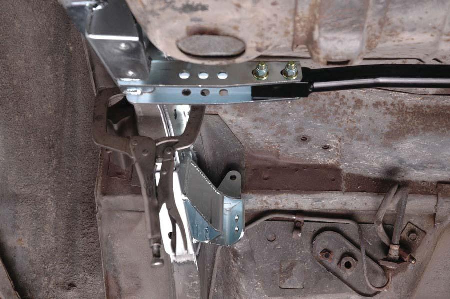 32. Install cradle into the car and align frame brackets with slotted holes in frame rail.