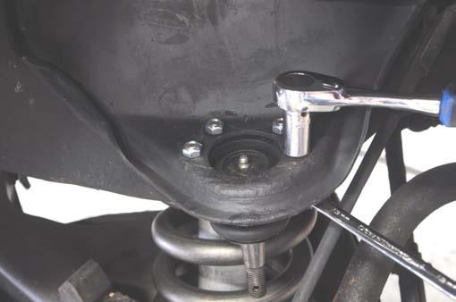 Remove the ball joint from the upper control arm. See Photo 18.