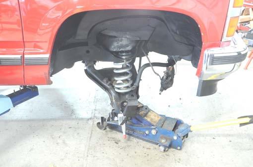 Tighten upper and lower ball joints using a 27mm wrench.