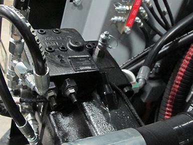Tighten the jamnut to lock in the adjustment. See Figure 13. Gauge Port 12. Shut-down the engine and remove the gauge test hose and pressure gauge. 13. Close and secure the rear gullwing guard. 14.