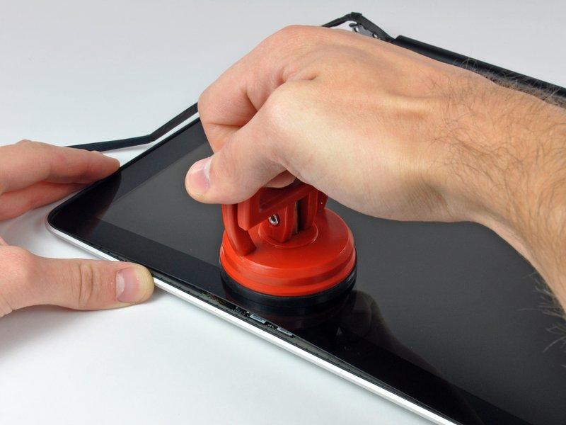 Attach a suction cup near the top edge of the glass display panel and use it to pull the glass panel