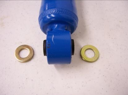 Install O.E. washer with larger inside diameter on the shock with the concave side up. Install first urethane bushing with smaller diameter portion up.