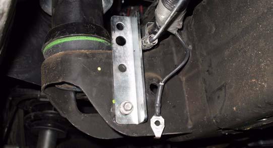 a. Install kit bracket (parking brake) onto second left cab mount with O.E. bolt.