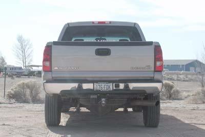 If equipped with a trailer hitch, remove two short and two