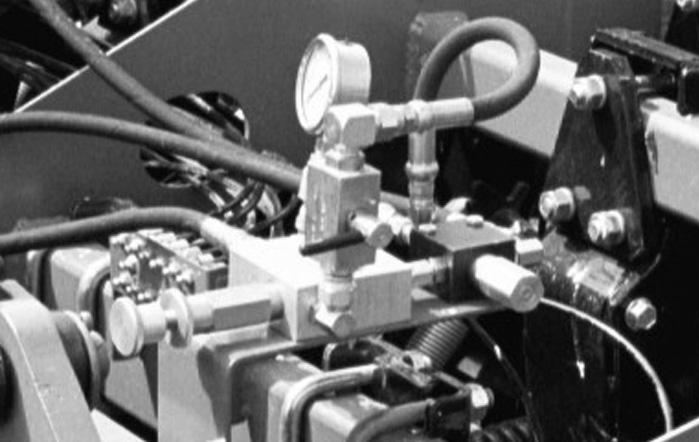 A hydraulic selector valve and an electric rocker switch control these operations.