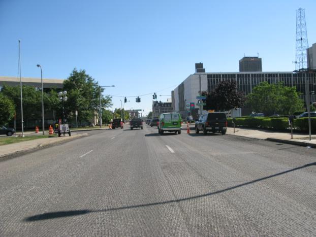 At Tupper Street it reduces to two travel lanes that merge with two NY 33 West offramp travel lanes creating a four lane approach at Genesee Street and then reduces to three travel lanes.